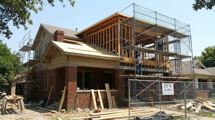 second story addition Dallas home under construction with scaffolding